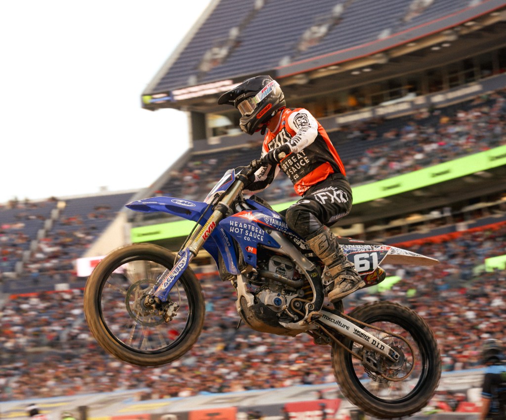 Cole Thompson number 61 flying through the air, captured from a low angle.