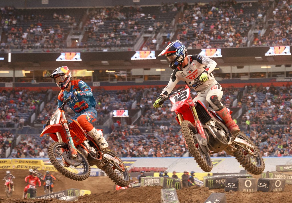 Aaron Plessinger number 7 passing Shane McElrath number 12 on the track.