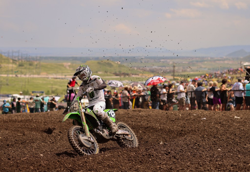 Ty Masterpool cornering hard with roost and golden mountain light.