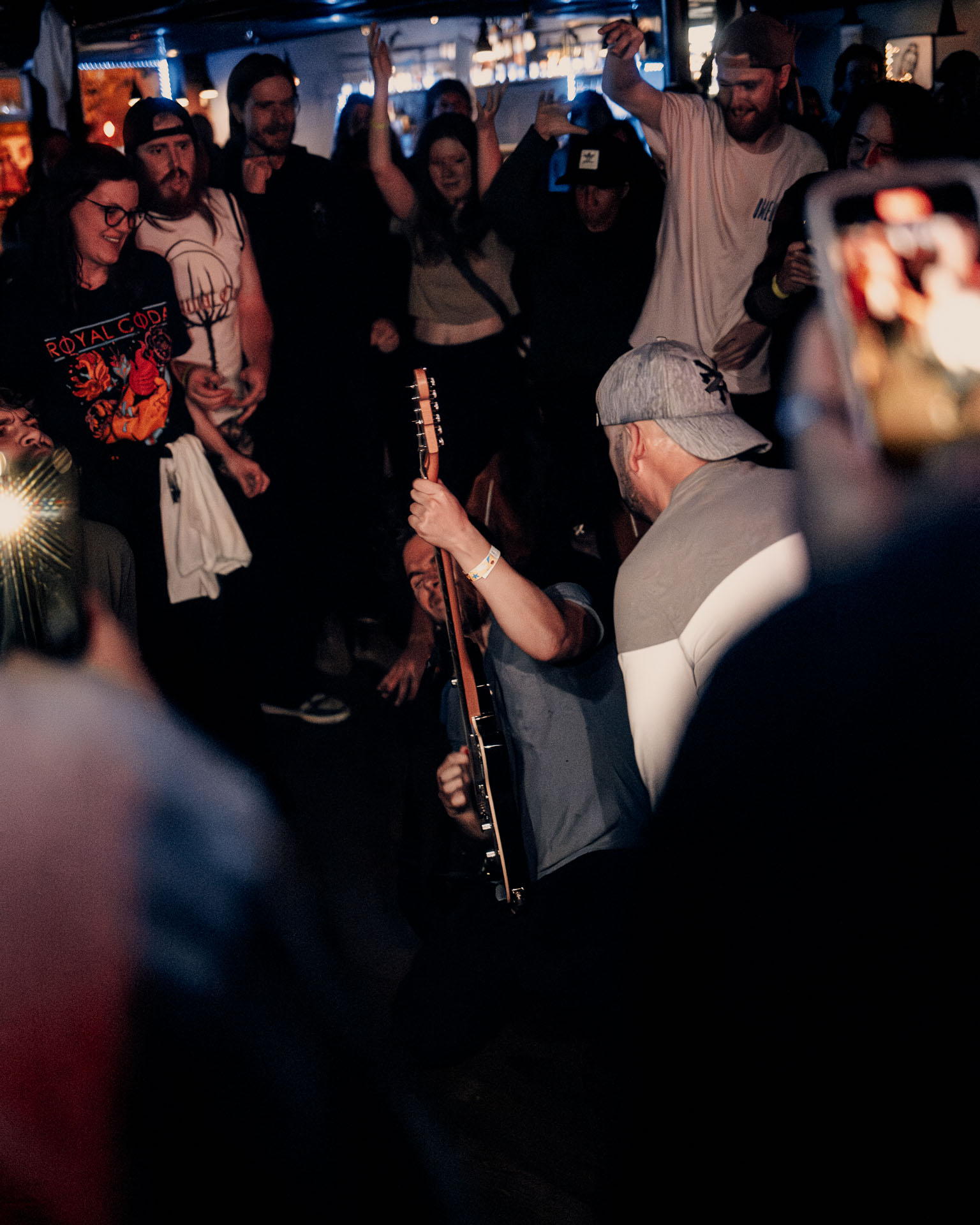 Greg Almeida performing guitar in the crowd during A Lot Like Birds concert in Denver, Colorado