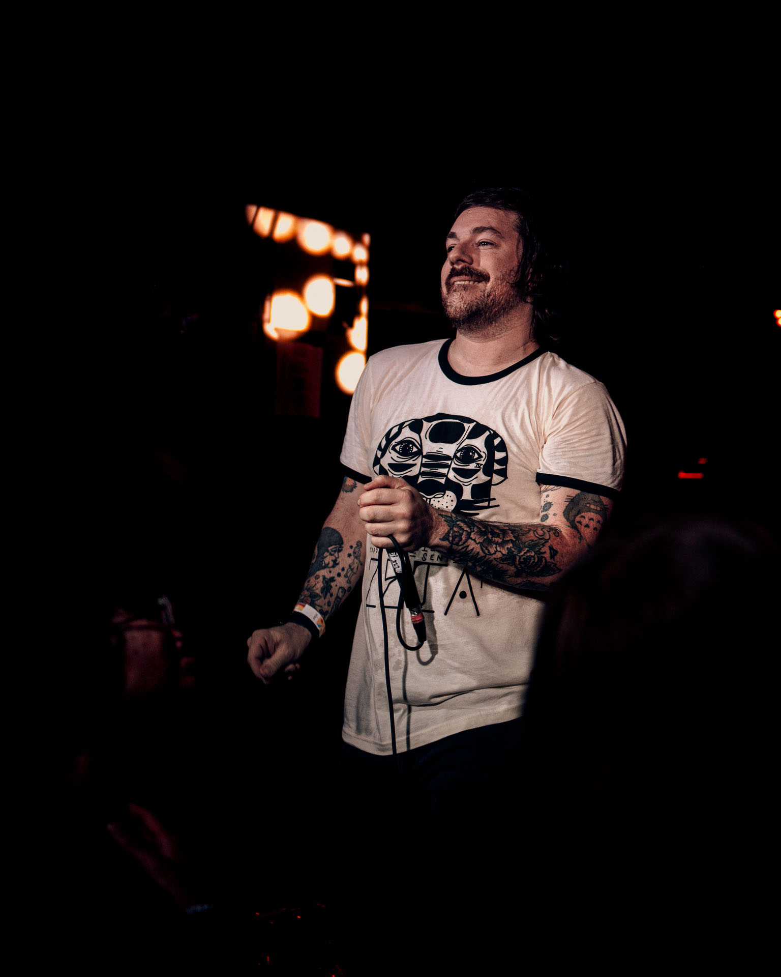 Kurt Travis of A Lot Like Birds dancing on stage, smiling