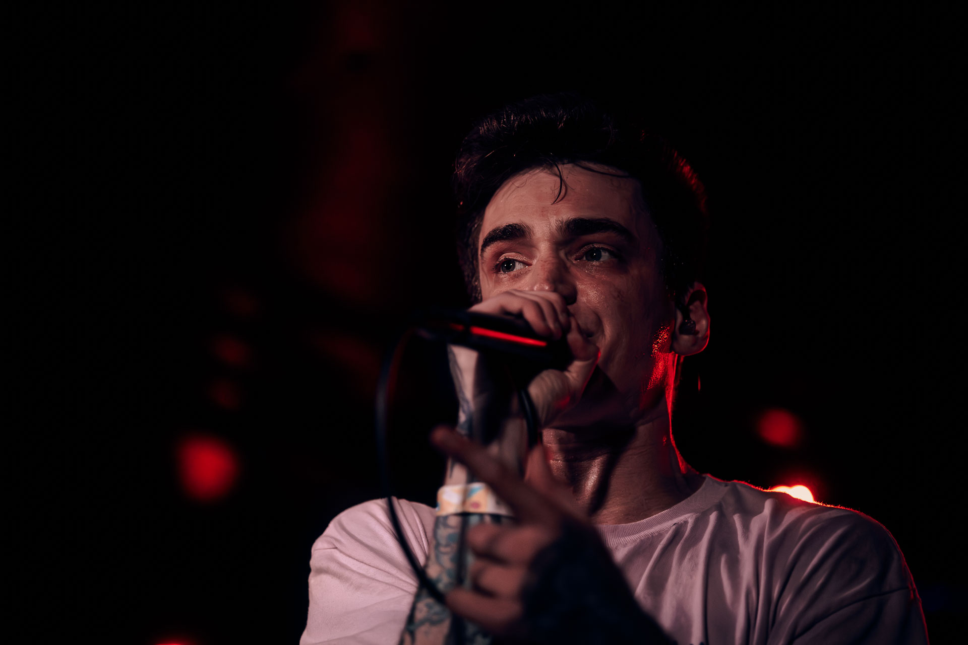 Andy Cizek singing on stage close up during A Lot Like Birds performance at HQ in Denver