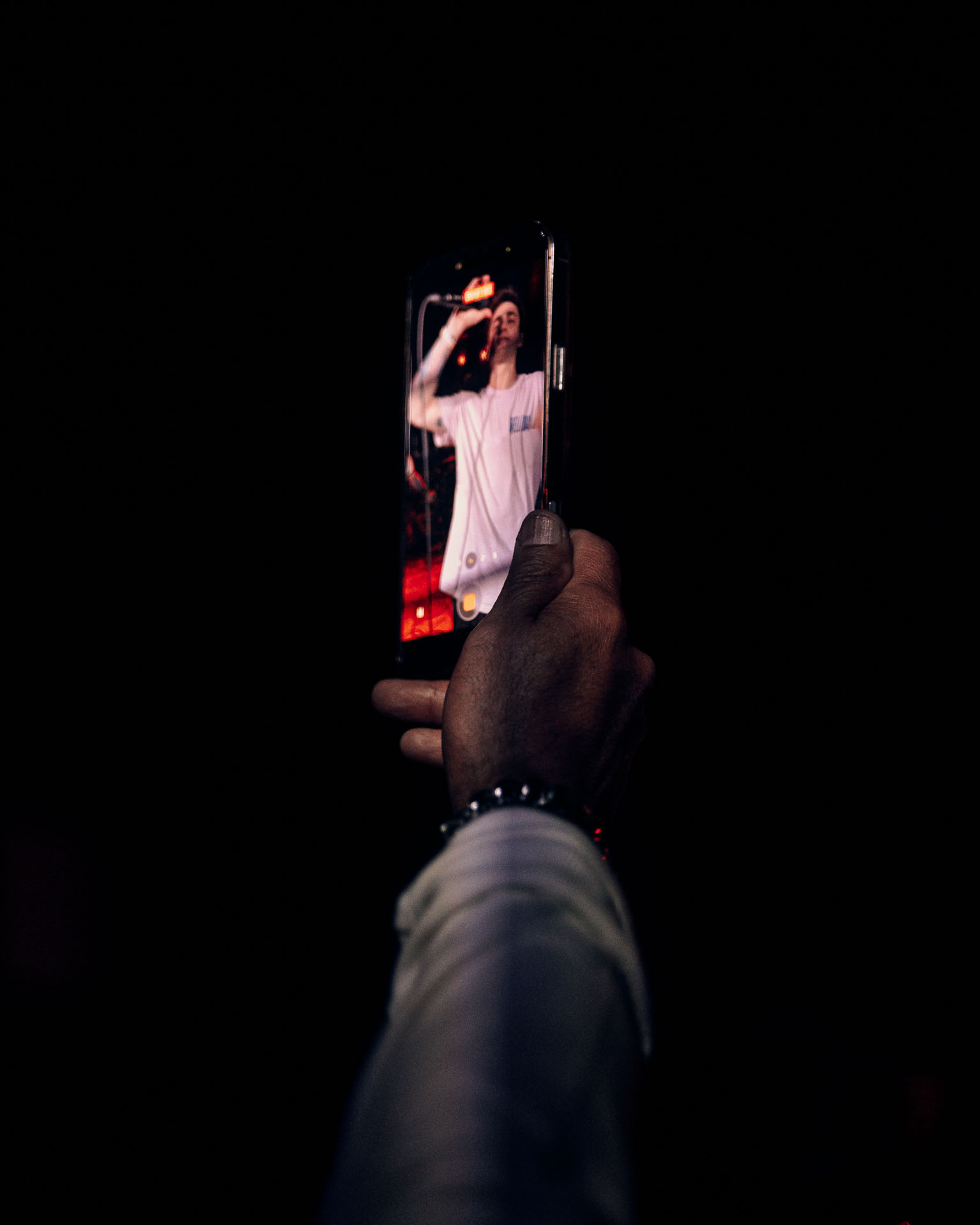 Fan holding up phone to record Andy Cizek performing during A Lot Like Birds concert at HQ in Denver, Colorado, USA