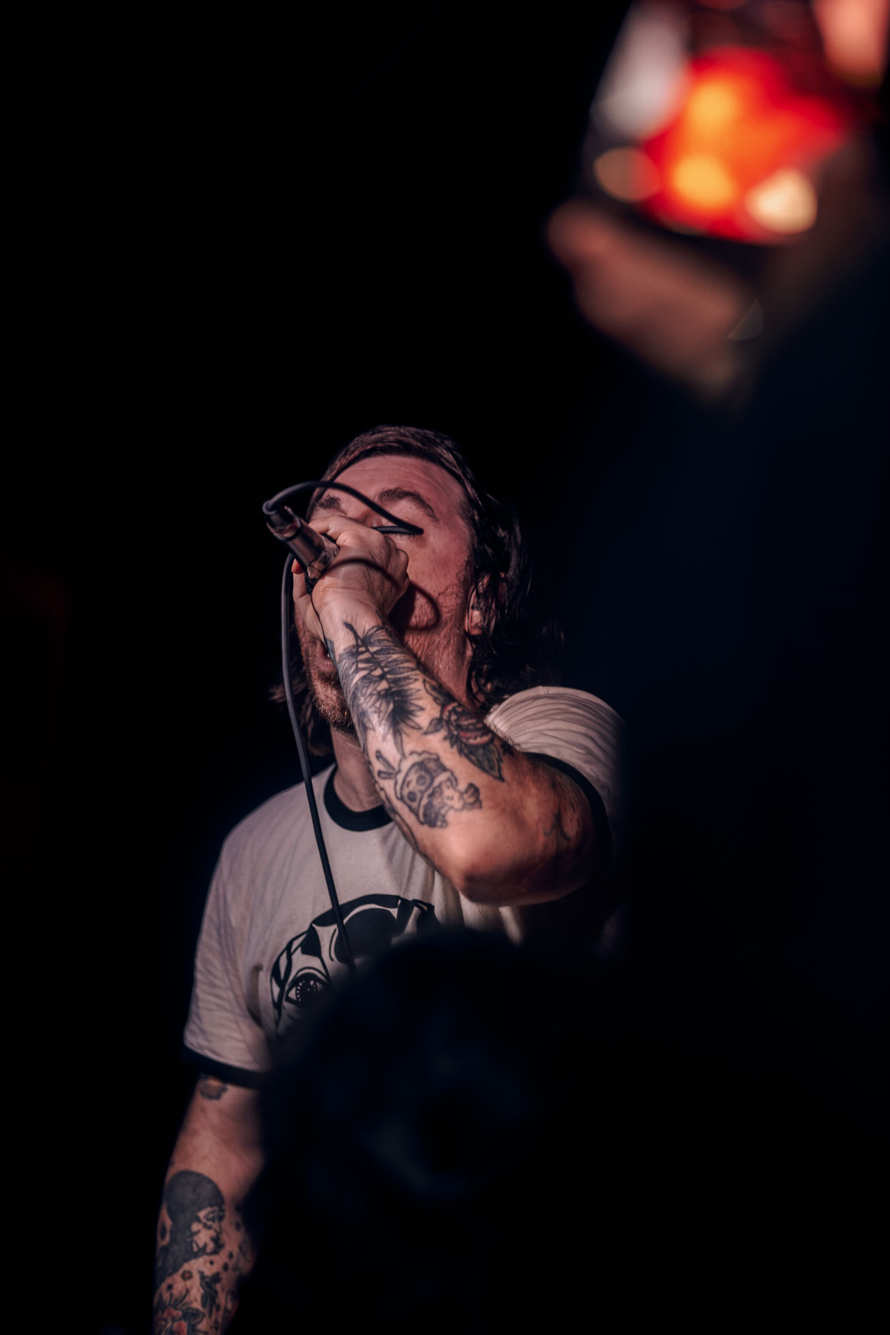 Kurt Travis performing on stage passionately during A Lot Like Birds performance at HQ in Denver