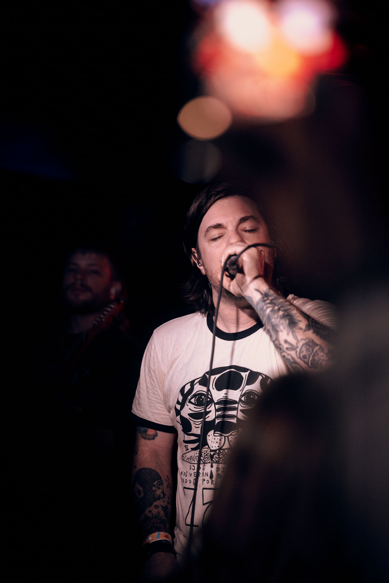 Kurt Travis performing on stage passionately during A Lot Like Birds performance at HQ in Denver