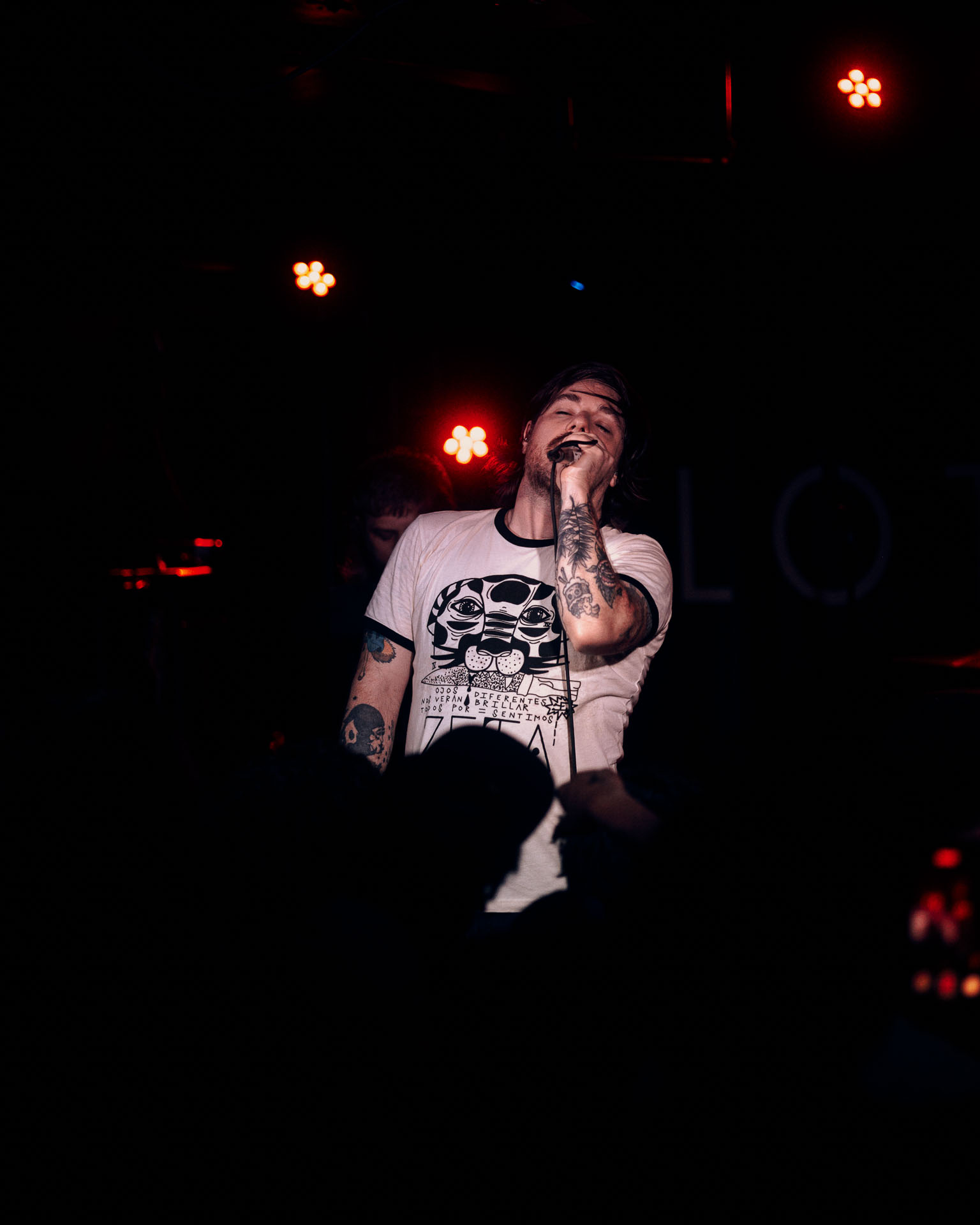 Kurt Travis performing on stage passionately during A Lot Like Birds performance at HQ in Denver