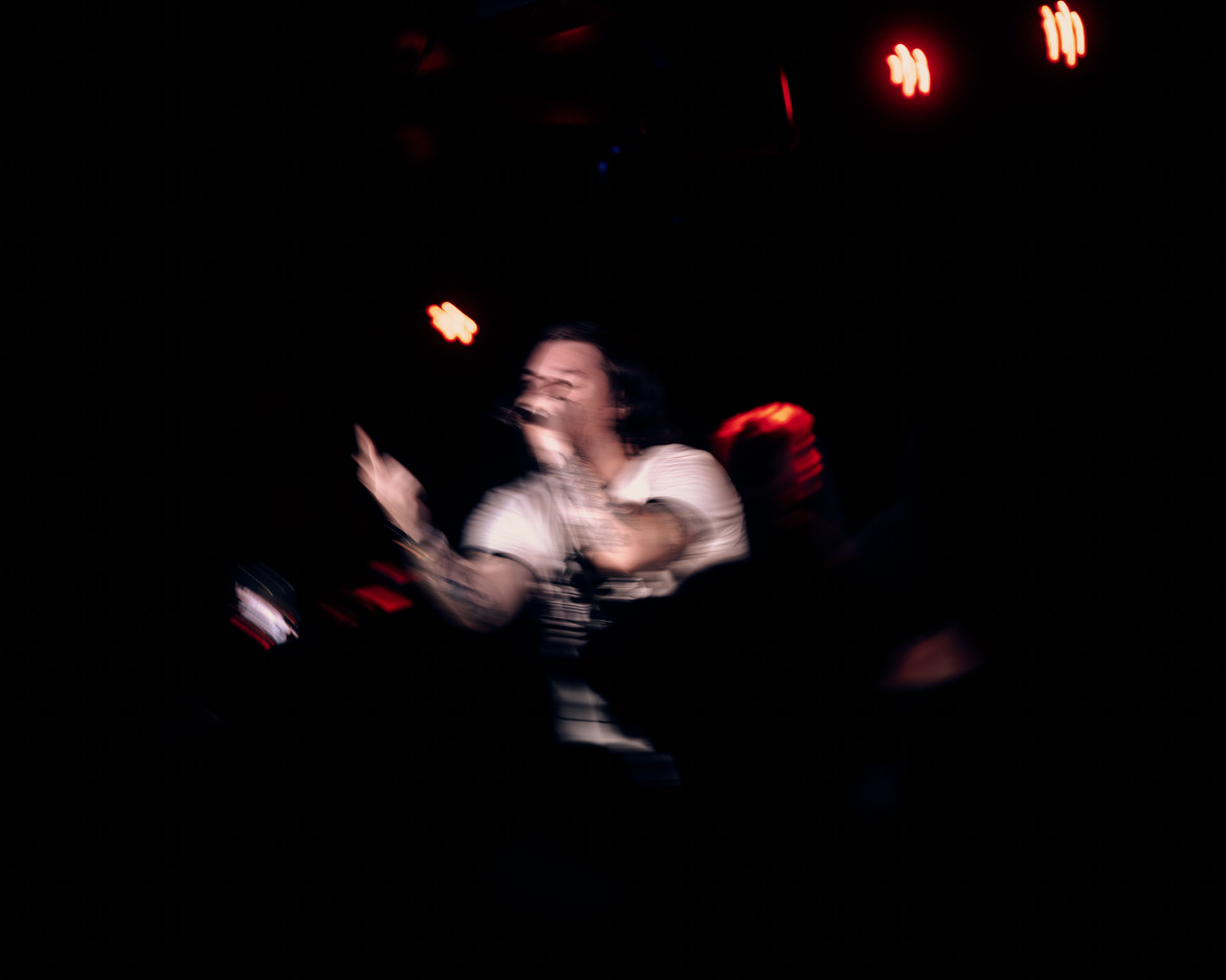 Kurt Travis with A lot Like Birds performing with passion to a lively crowd, abstract