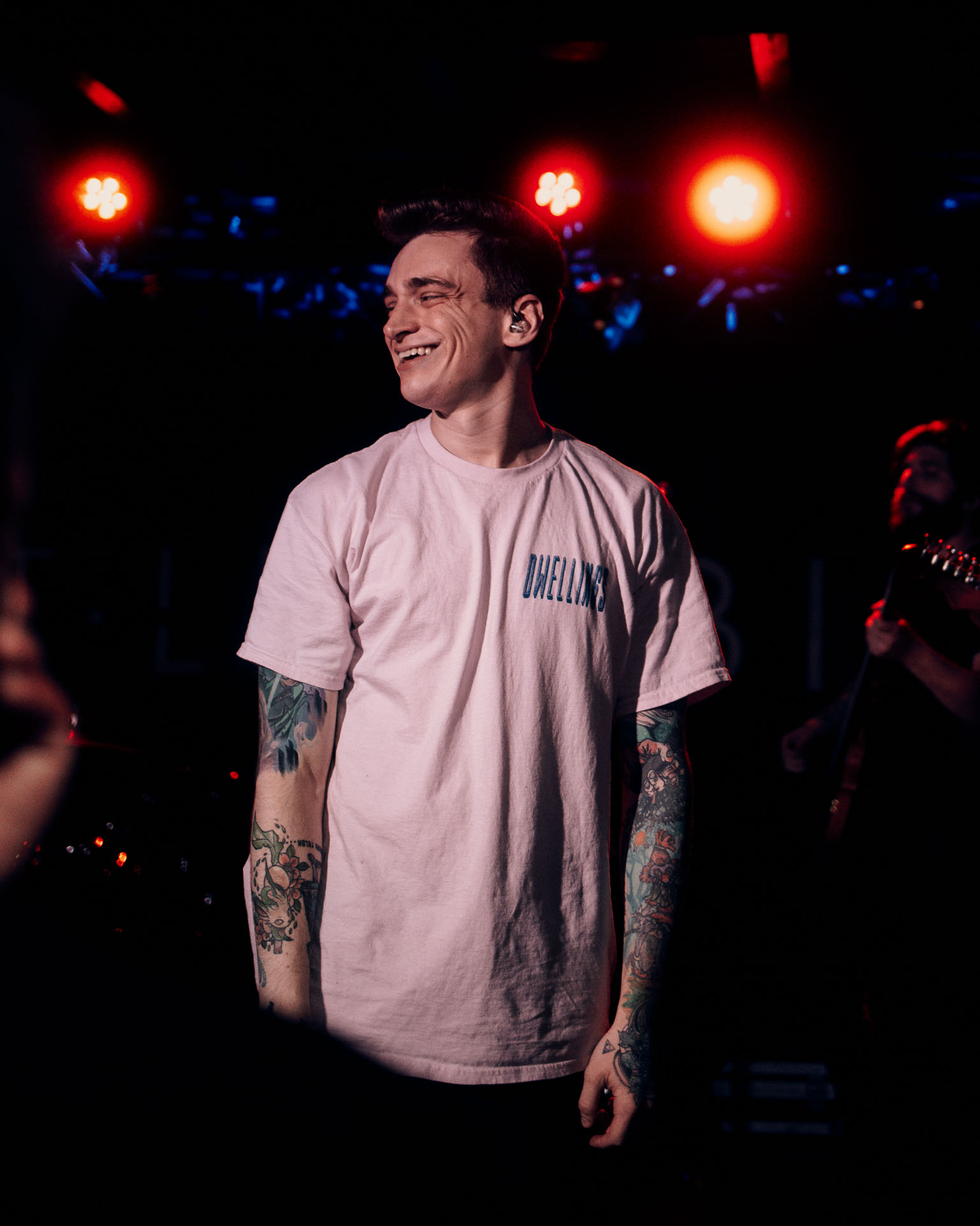 Andy Cizek smiling on stage during A Lot Like Birds concert