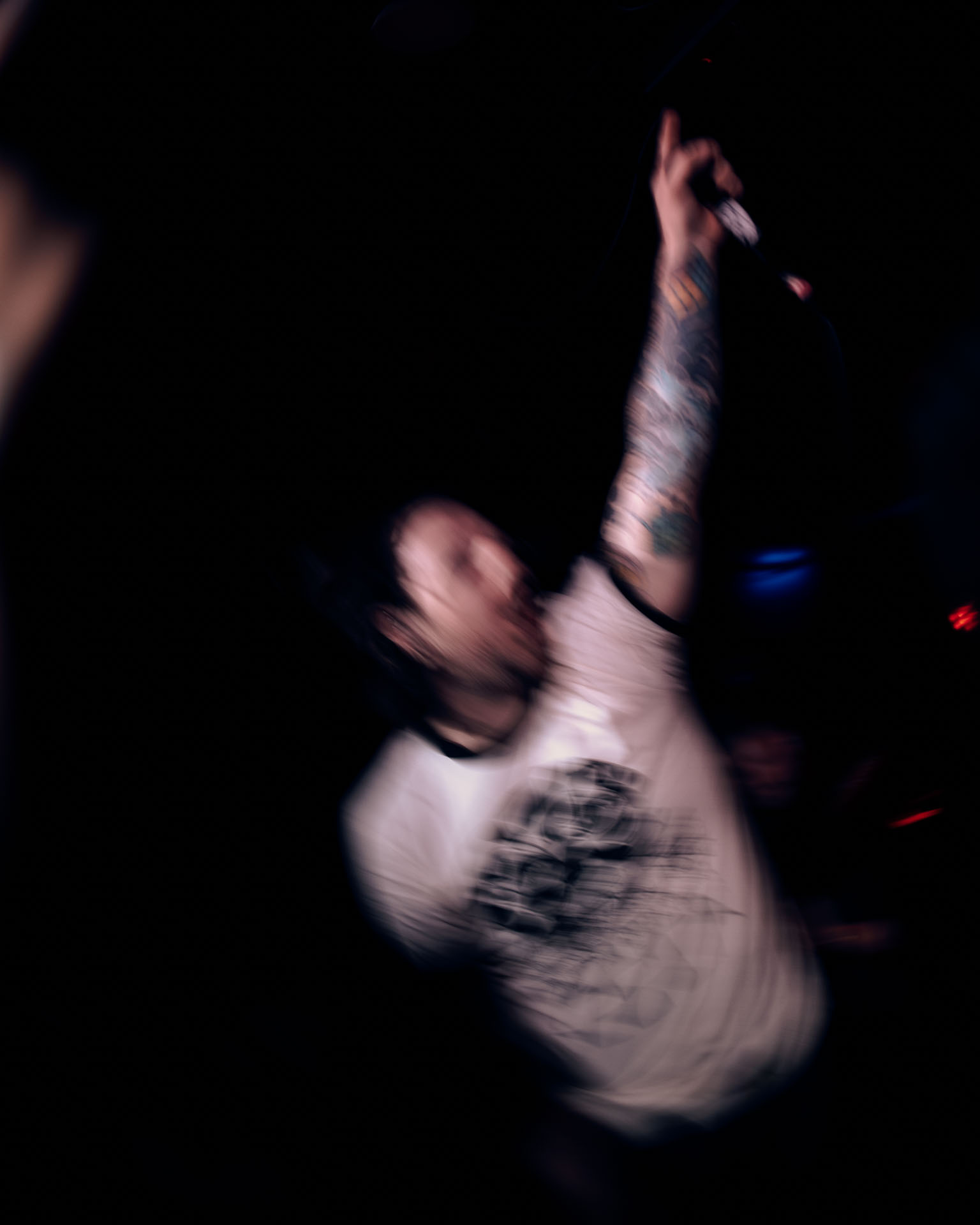 Kurt Travis performing on stage passionately during A Lot Like Birds performance at HQ in Denver