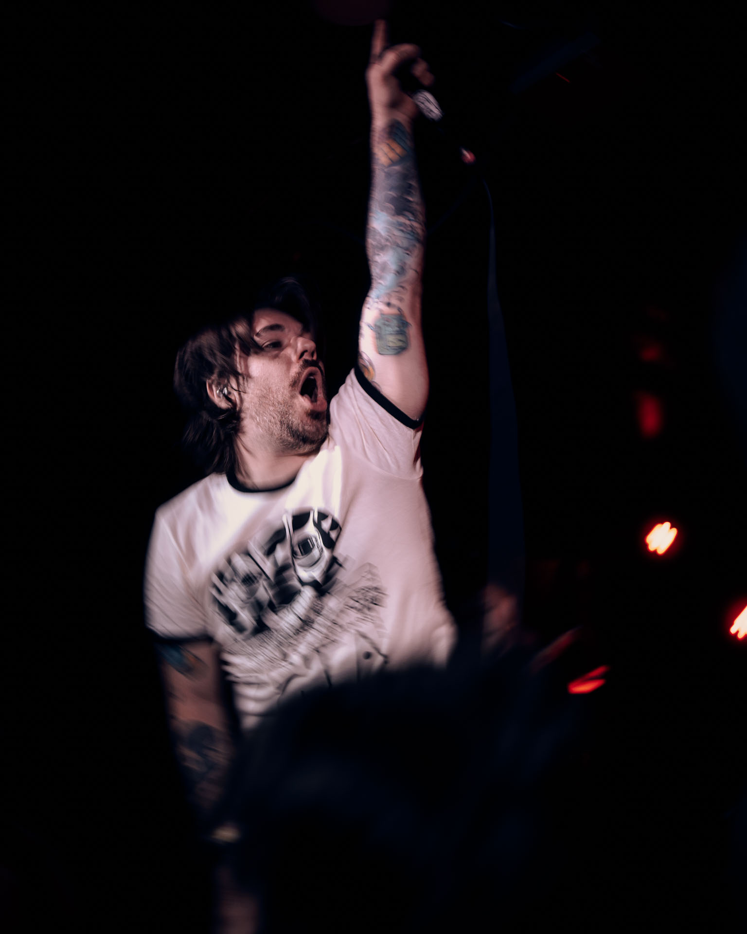 Kurt Travis performing on stage passionately during A Lot Like Birds performance at HQ in Denver
