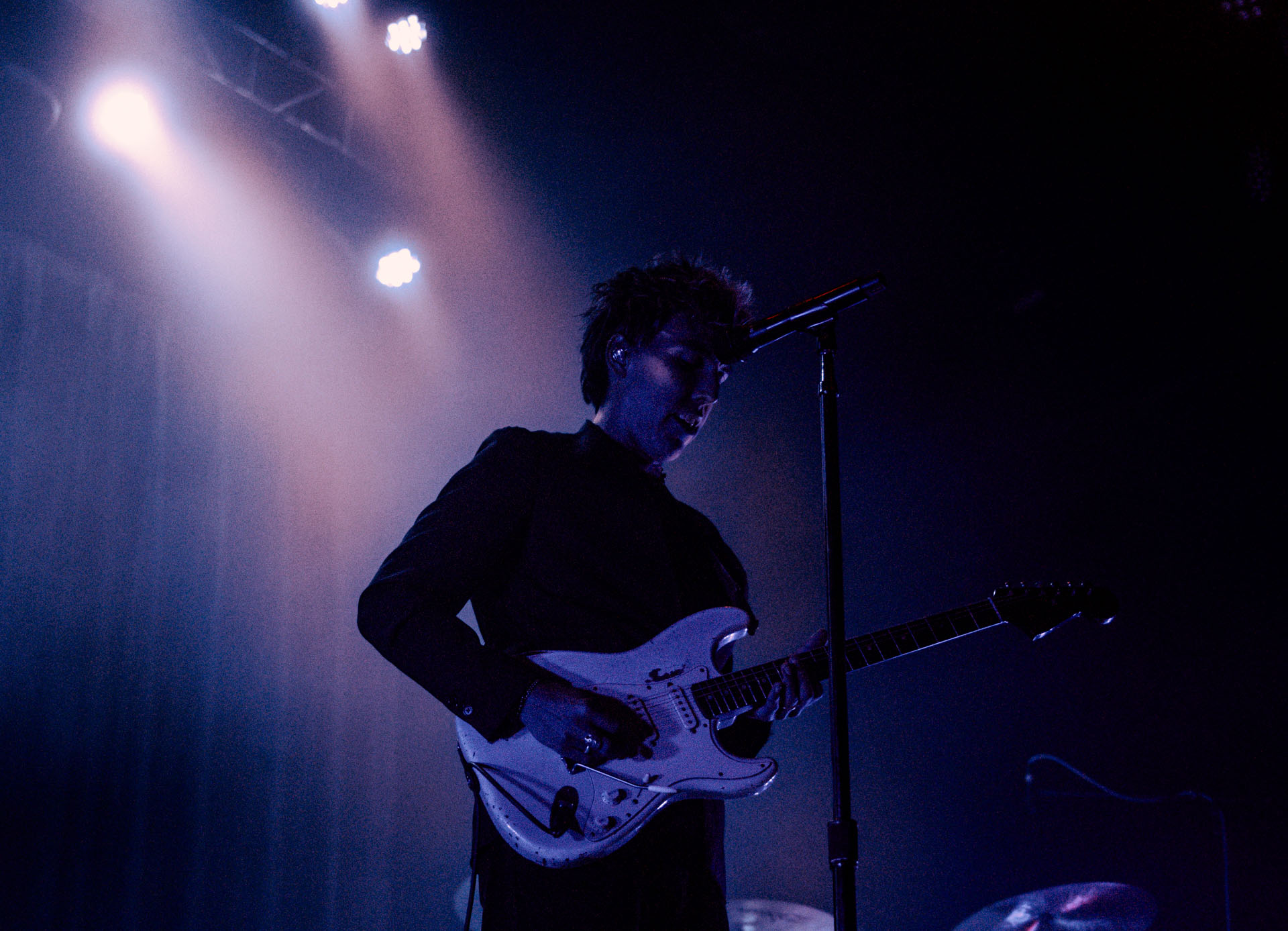 Christo Bowman from Bad Suns singing on stage in Denver, Colorado 2025