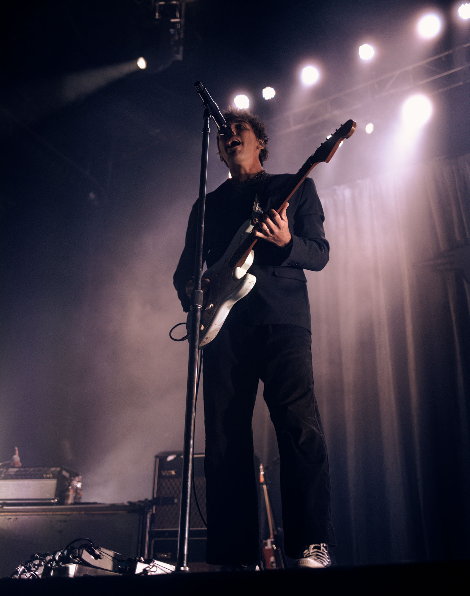 Christo Bowman from Bad Suns singing on stage in Denver, Colorado 2025