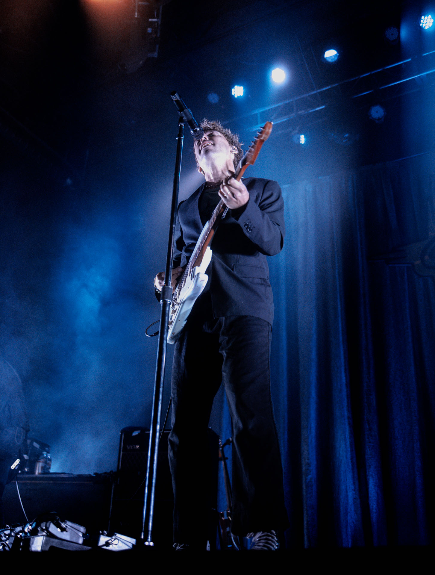 Christo Bowman from Bad Suns singing on stage in Denver, Colorado 2025