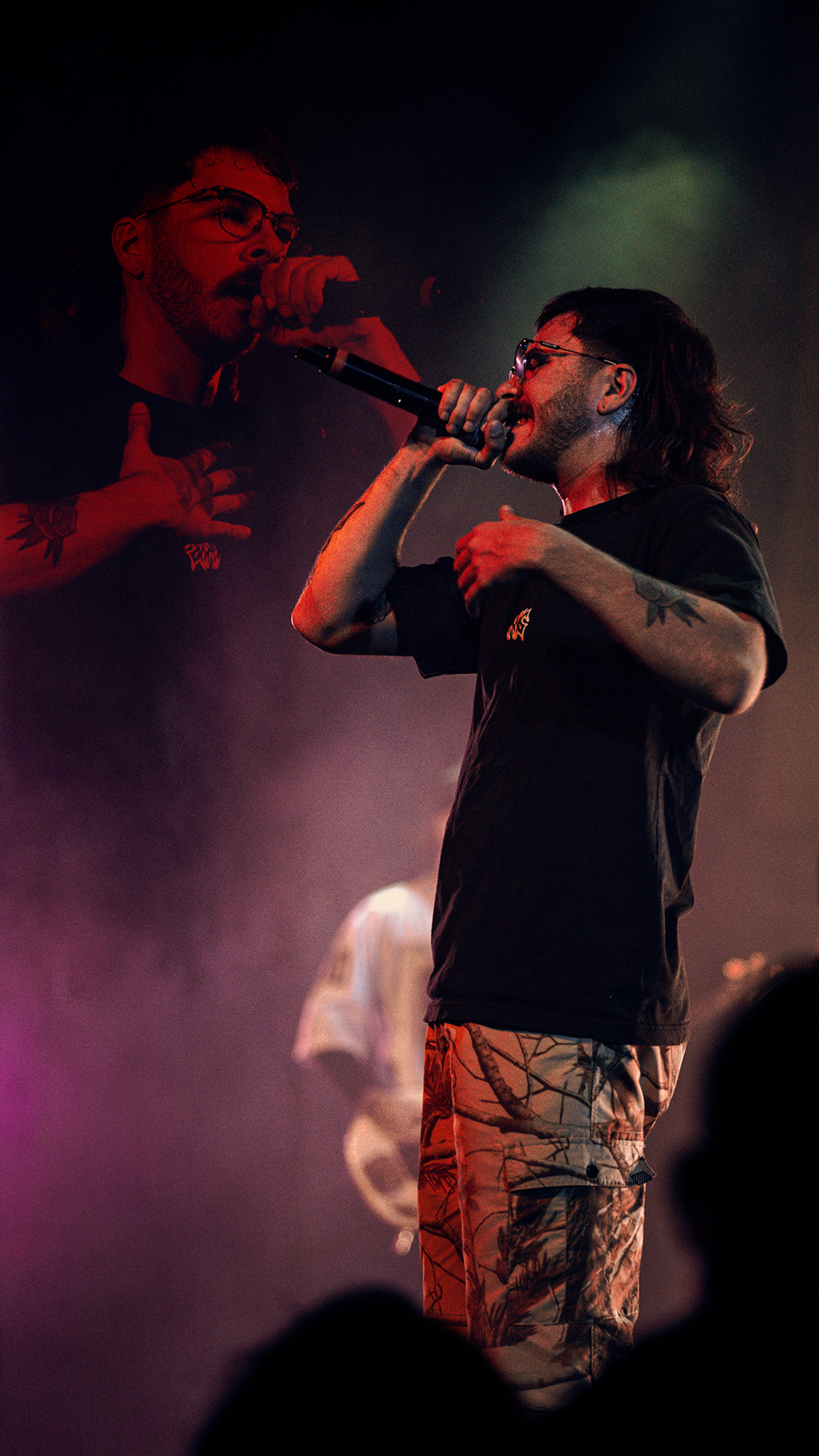 Belmont lead vocalist, Taz Johnson, passionately singing into the mic during their Denver concert at The Oriental Theater.