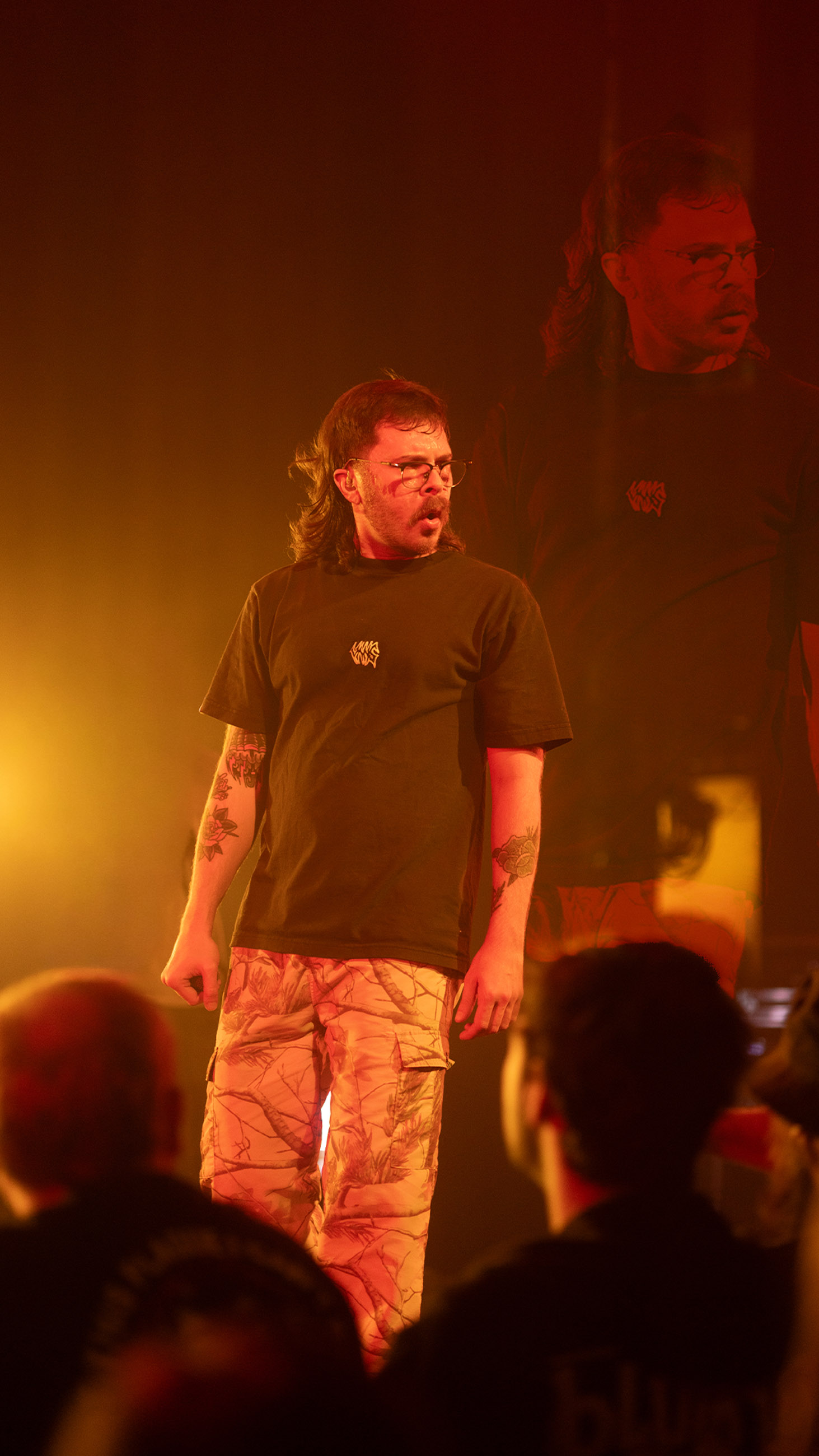 Belmont lead vocalist, Taz Johnson, passionately singing into the mic during their Denver concert at The Oriental Theater.