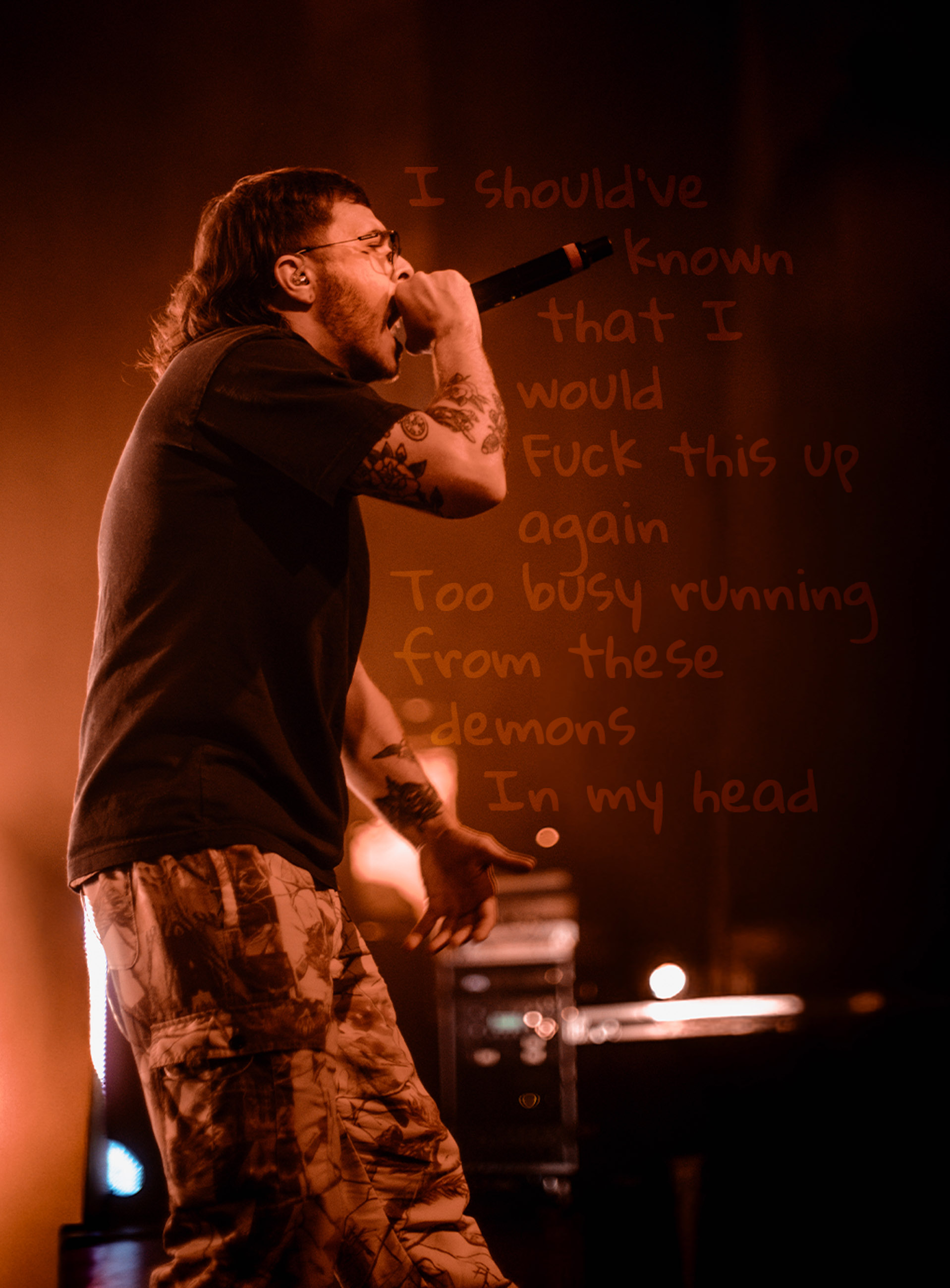 Belmont lead vocalist, Taz Johnson, passionately singing into the mic during their Denver concert at The Oriental Theater.