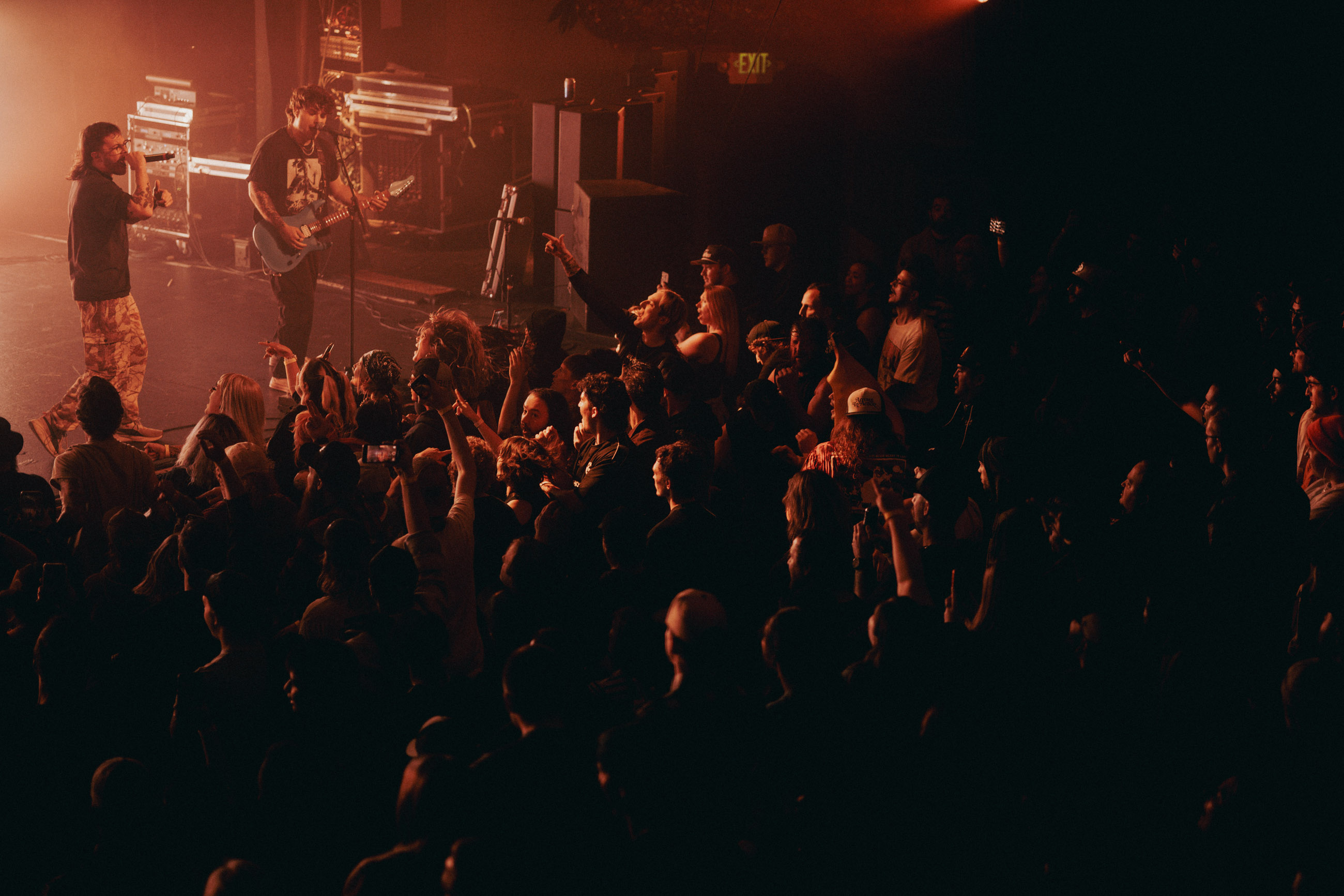 Belmont guitarist playing under stage lights during a live performance in Denver, Colorado.