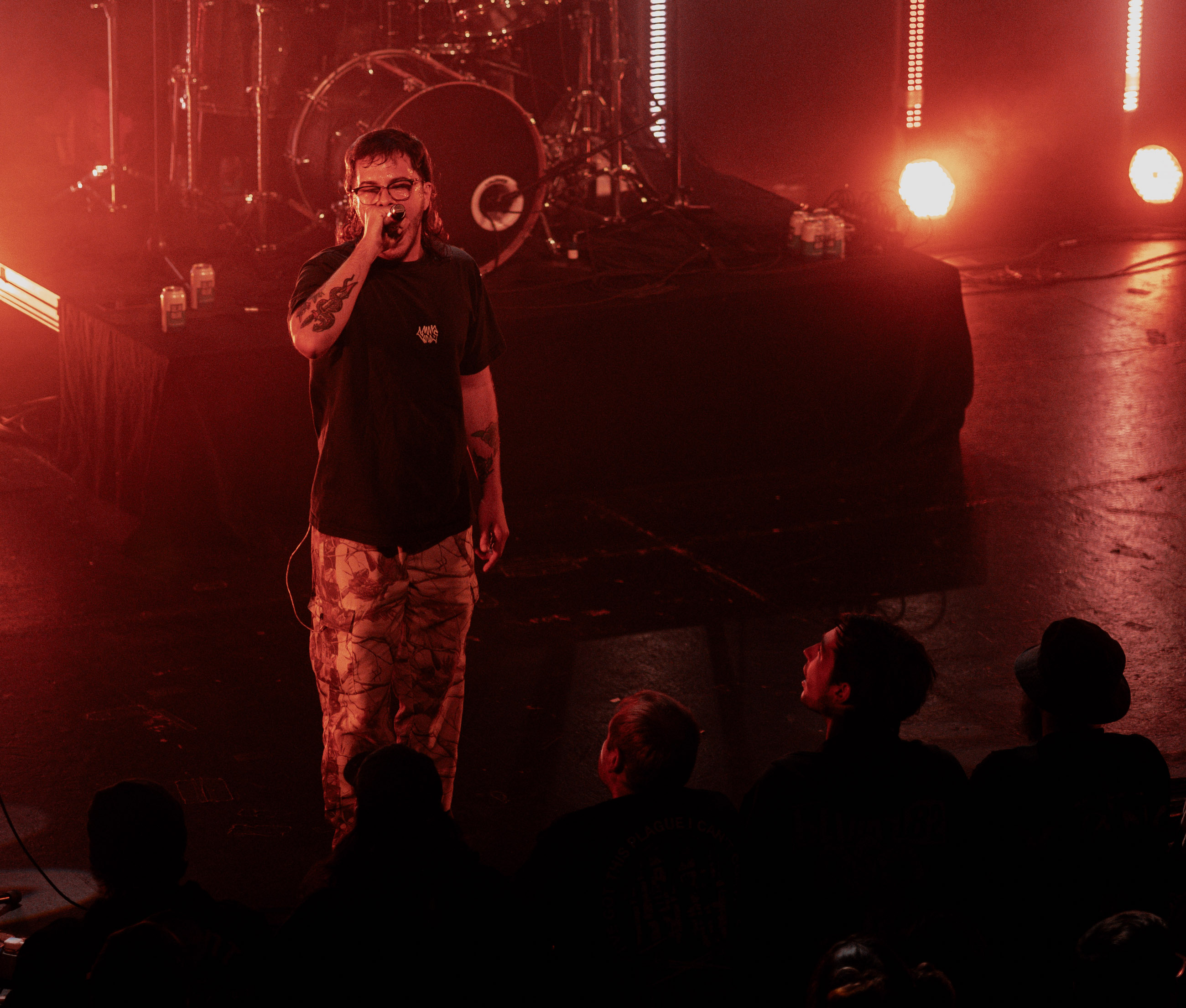 Belmont lead vocalist, Taz Johnson, passionately singing into the mic during their Denver concert at The Oriental Theater.