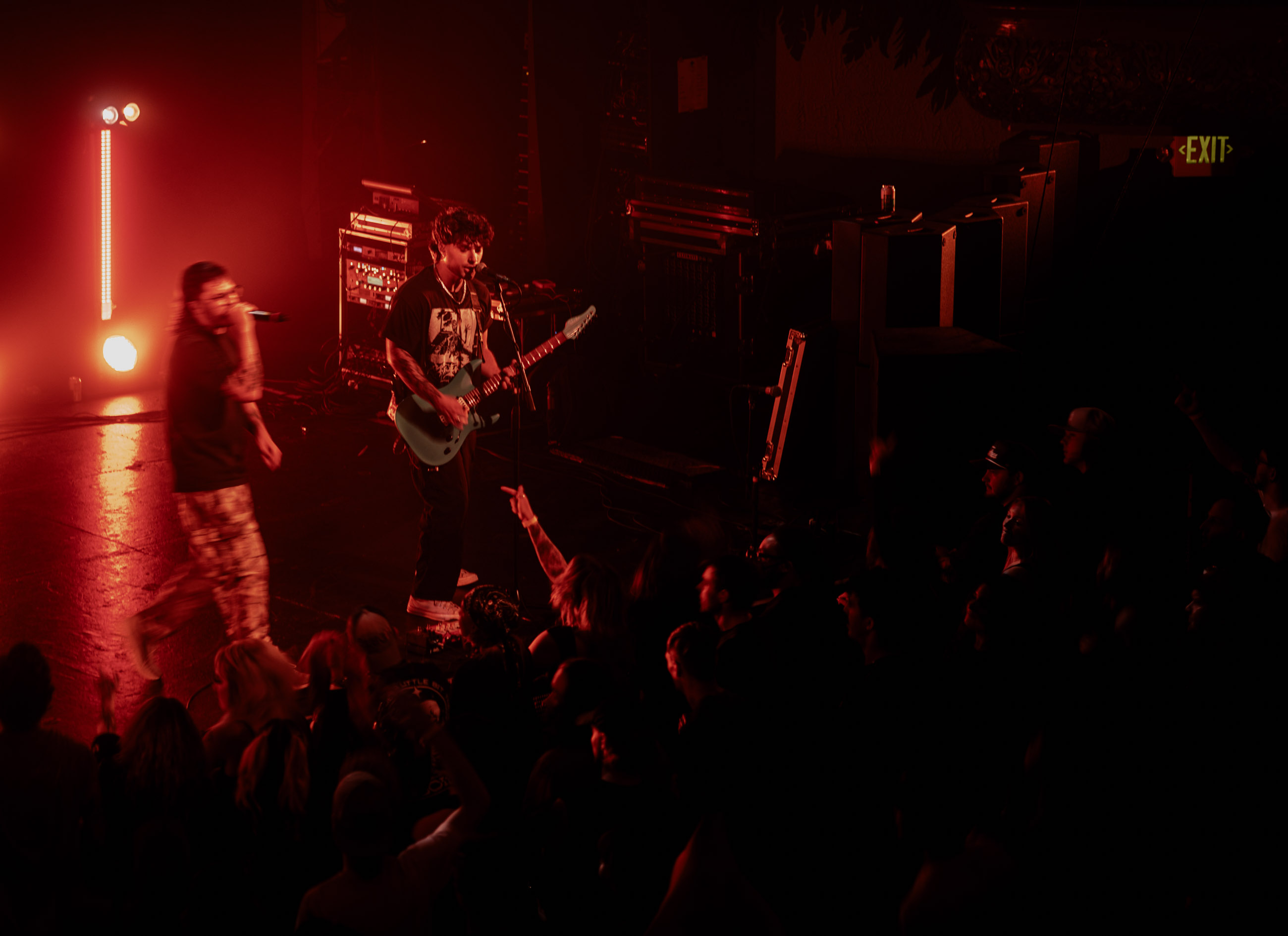 Belmont band playing under stage lights during a live performance in Denver, Colorado.