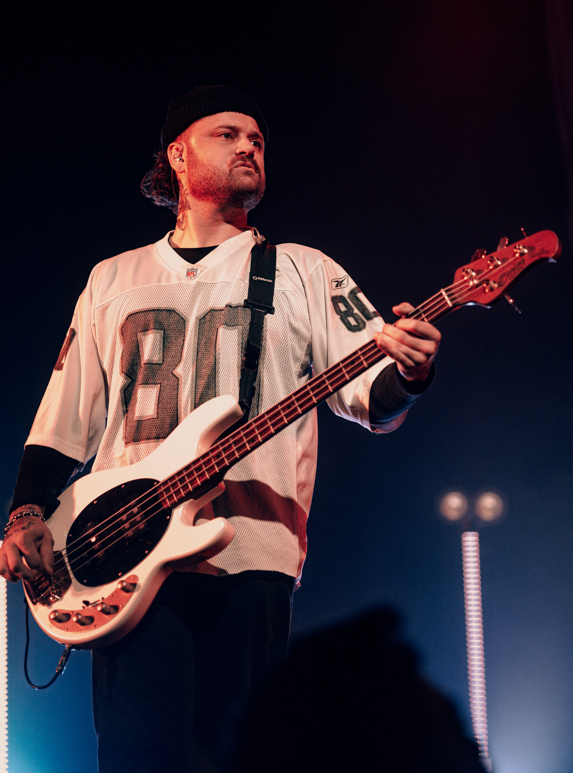 Belmont bassist playing under stage lights during a live performance in Denver, Colorado.