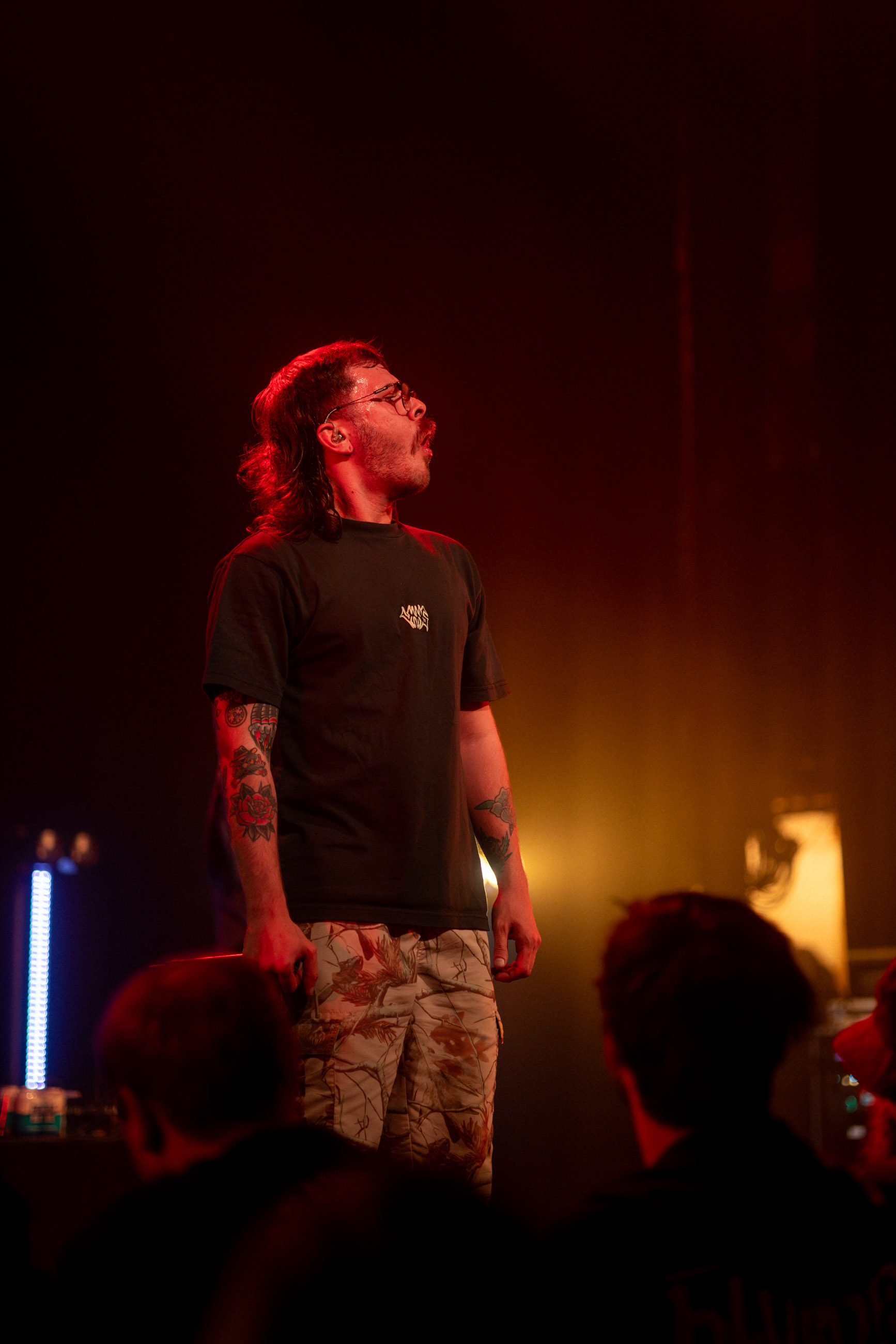 Belmont lead vocalist, Taz Johnson, passionately singing into the mic during their Denver concert at The Oriental Theater.