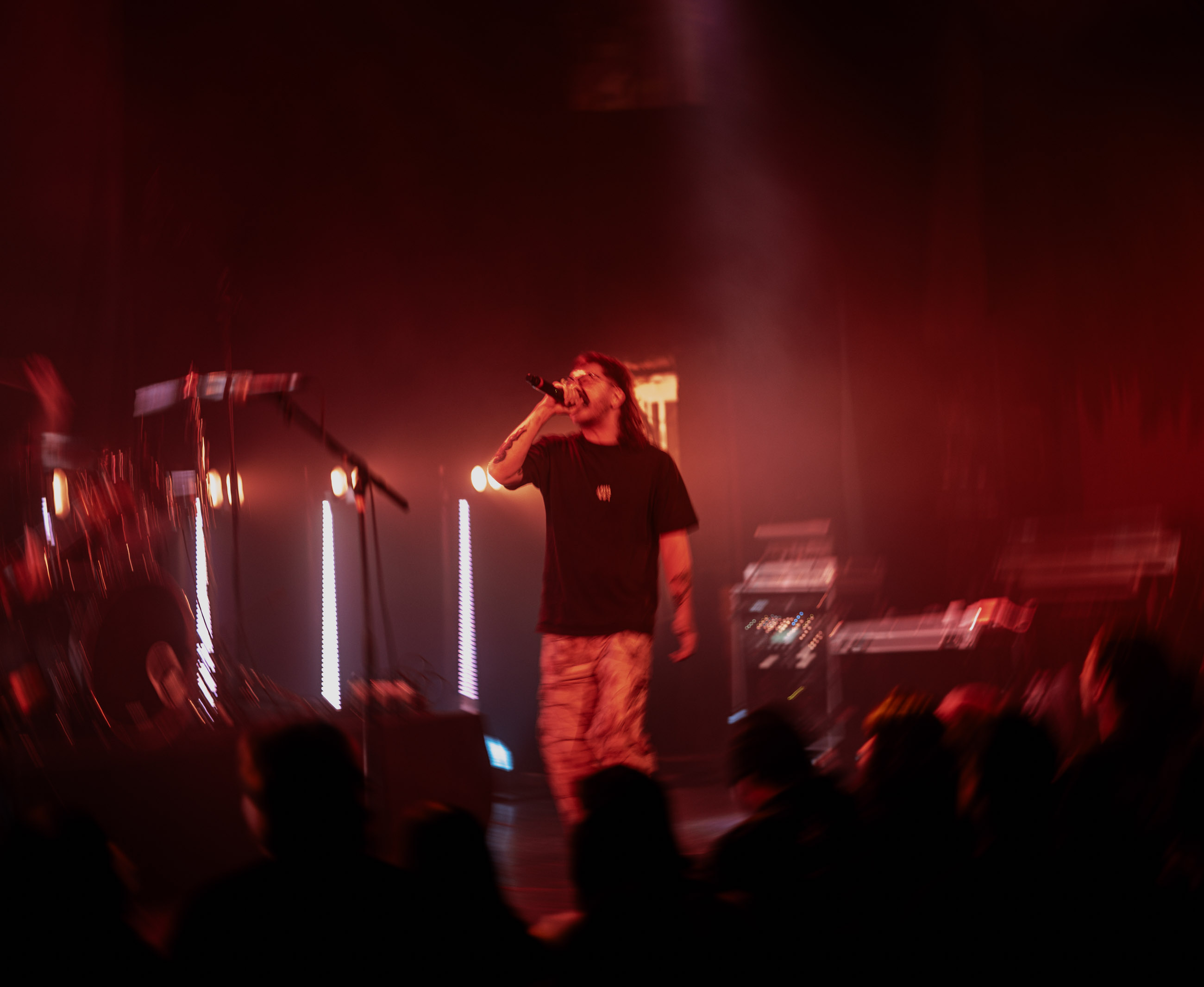 Belmont lead vocalist, Taz Johnson, passionately singing into the mic during their Denver concert at The Oriental Theater.