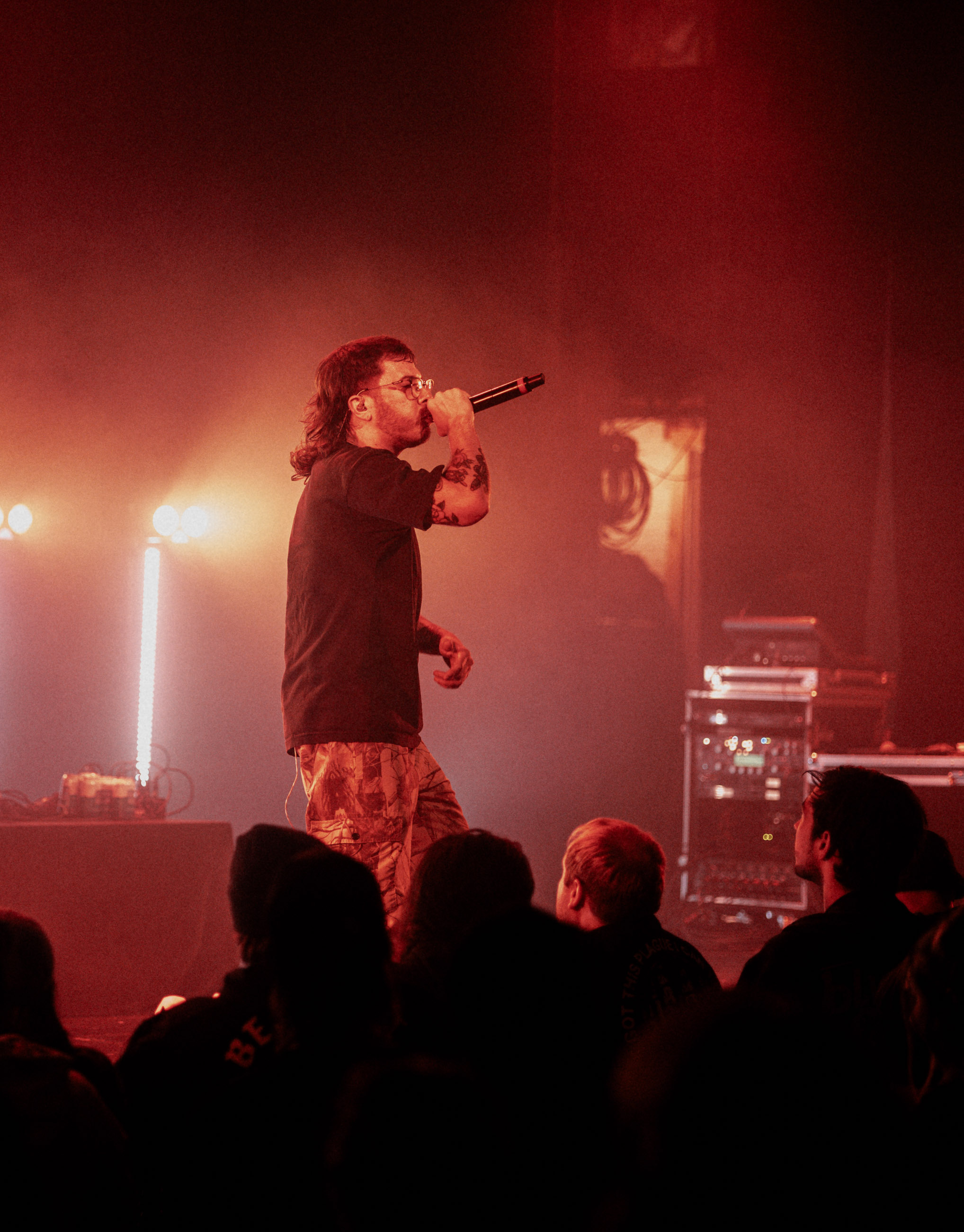 Belmont lead vocalist, Taz Johnson, passionately singing into the mic during their Denver concert at The Oriental Theater.