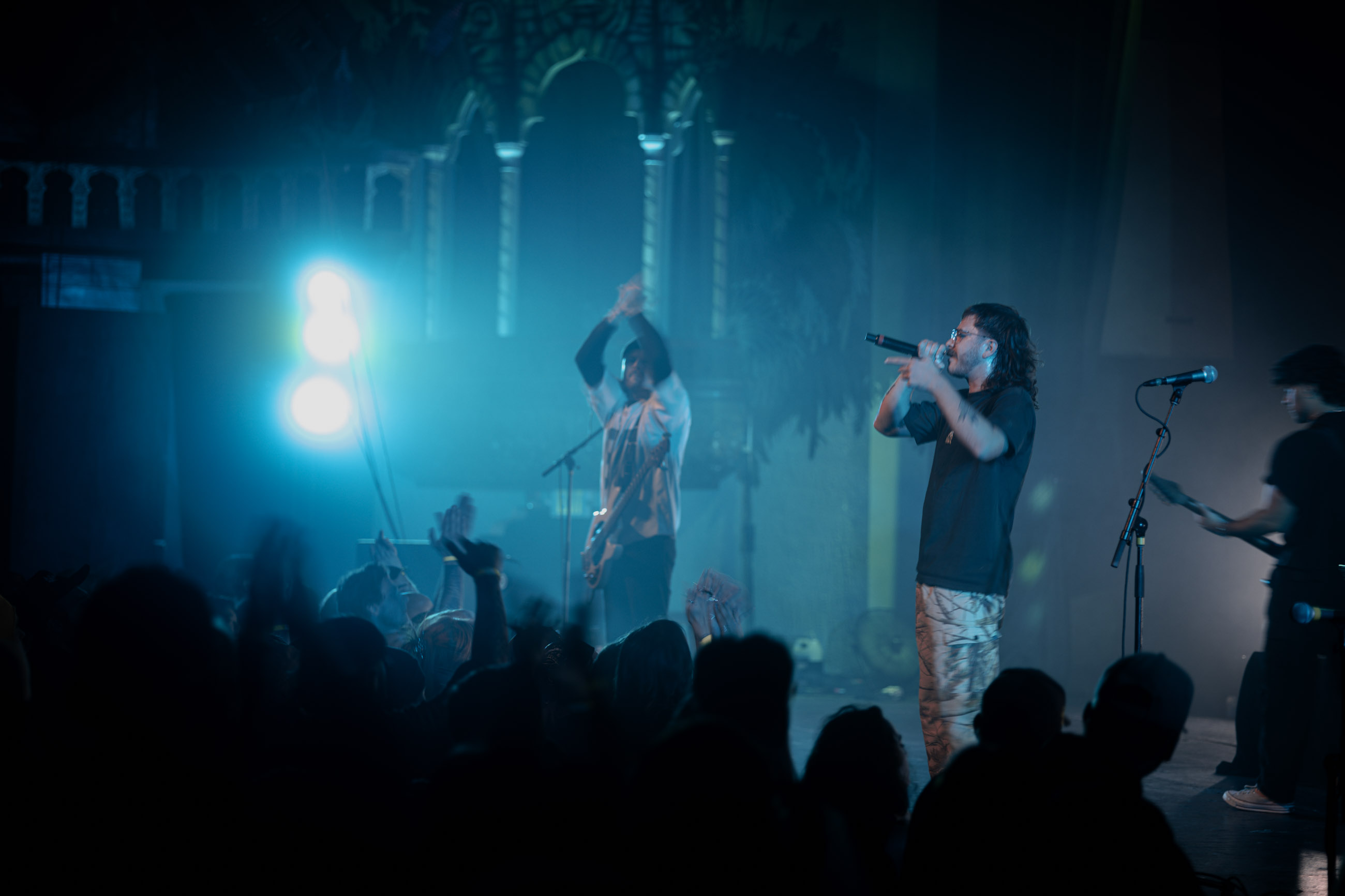 Belmont lead vocalist, Taz Johnson, passionately singing into the mic during their Denver concert at The Oriental Theater.