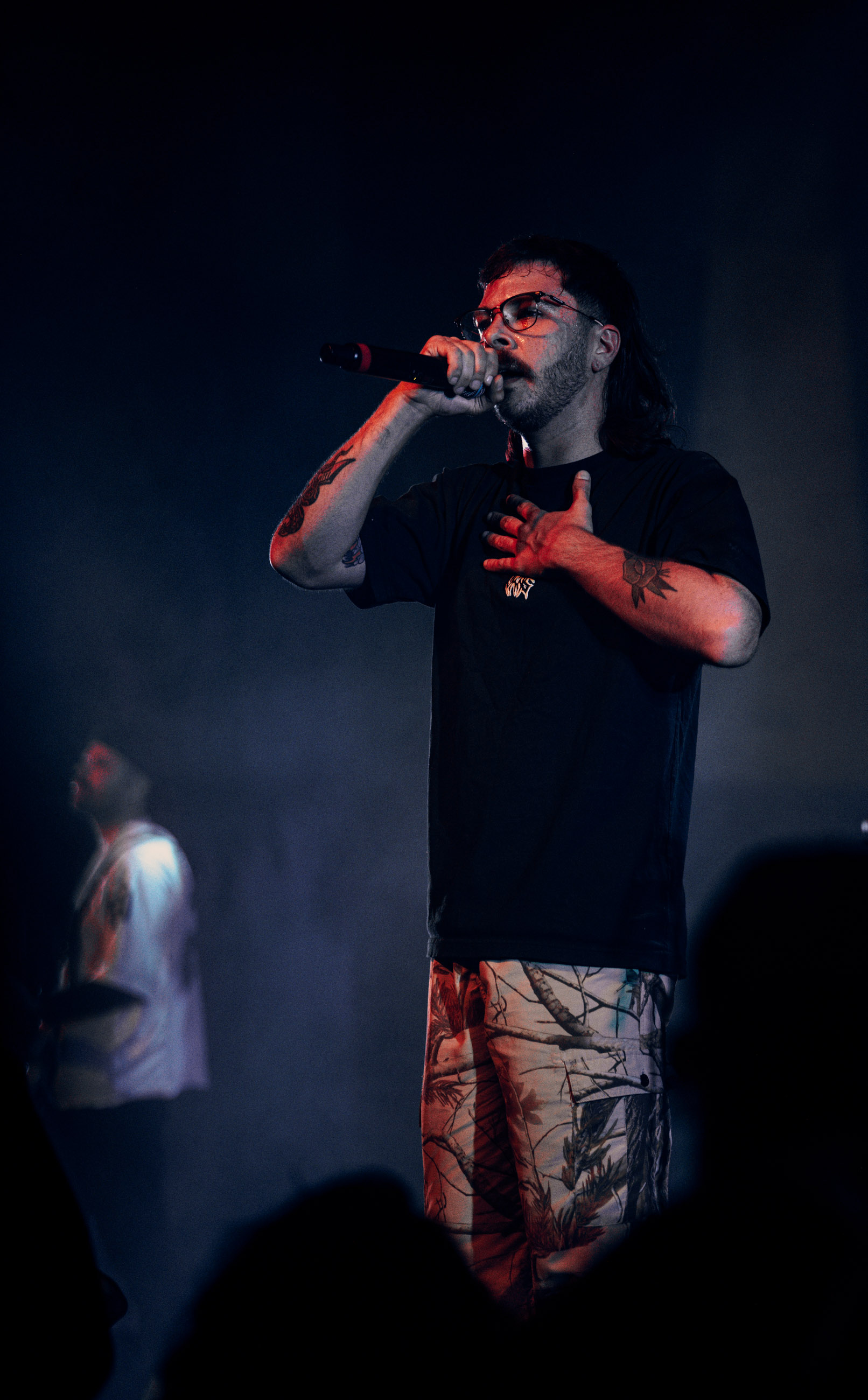 Belmont lead vocalist, Taz Johnson, passionately singing into the mic during their Denver concert at The Oriental Theater.