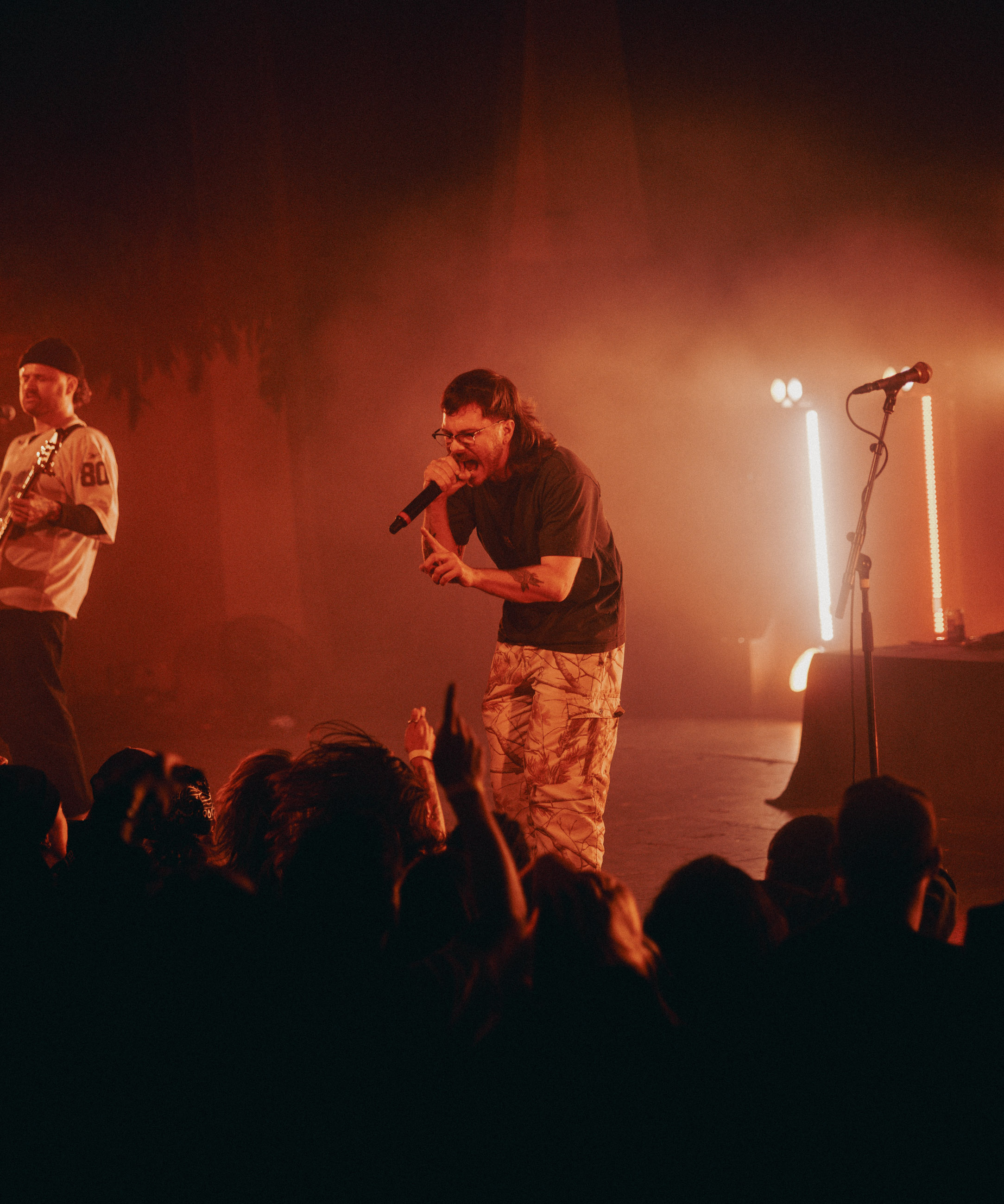 Belmont lead vocalist, Taz Johnson, passionately singing into the mic during their Denver concert at The Oriental Theater.