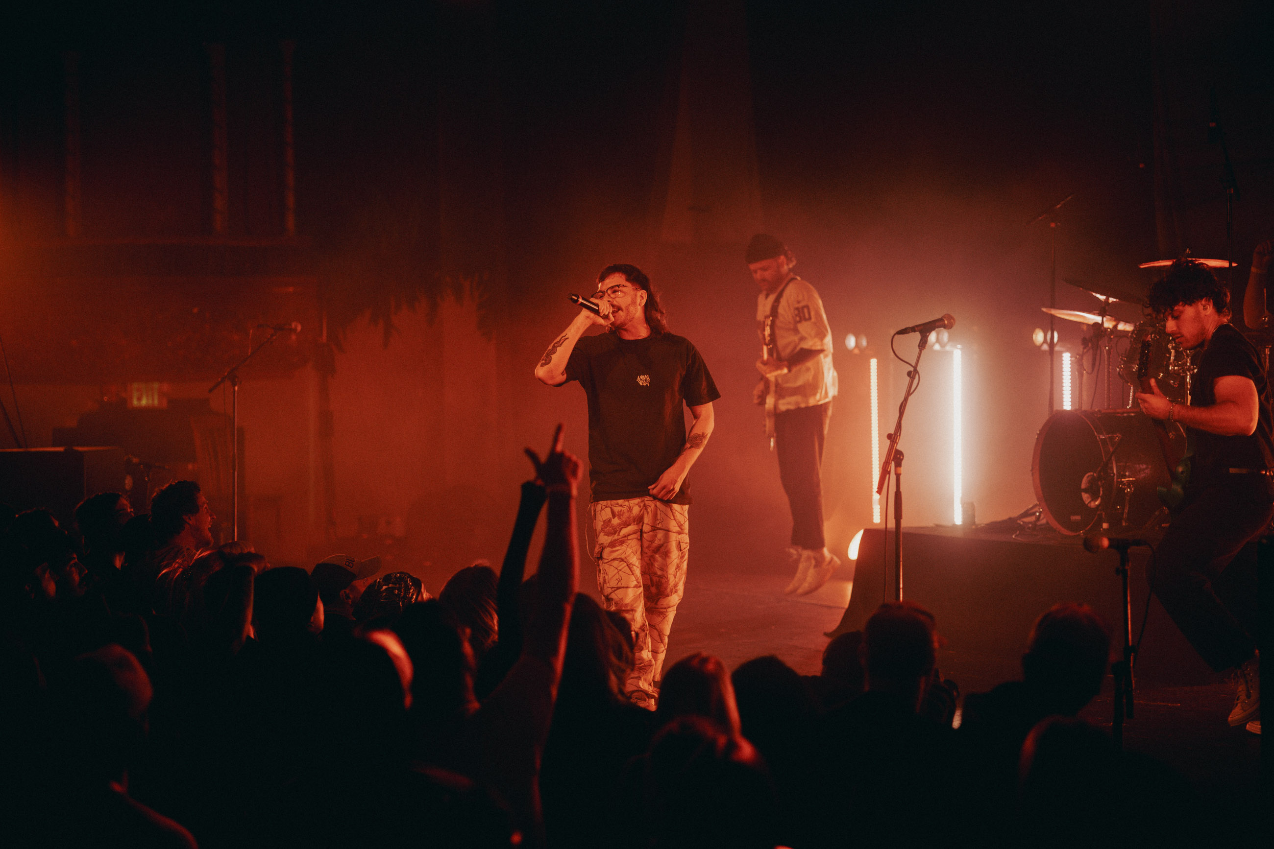 Belmont lead vocalist, Taz Johnson, passionately singing into the mic during their Denver concert at The Oriental Theater.
