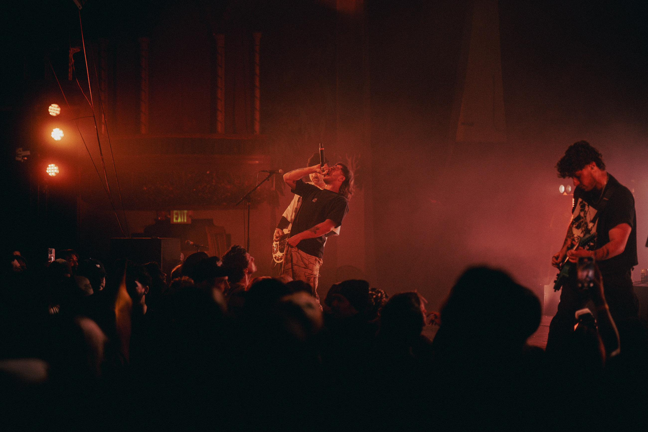 Belmont lead vocalist, Taz Johnson, passionately singing into the mic during their Denver concert at The Oriental Theater.
