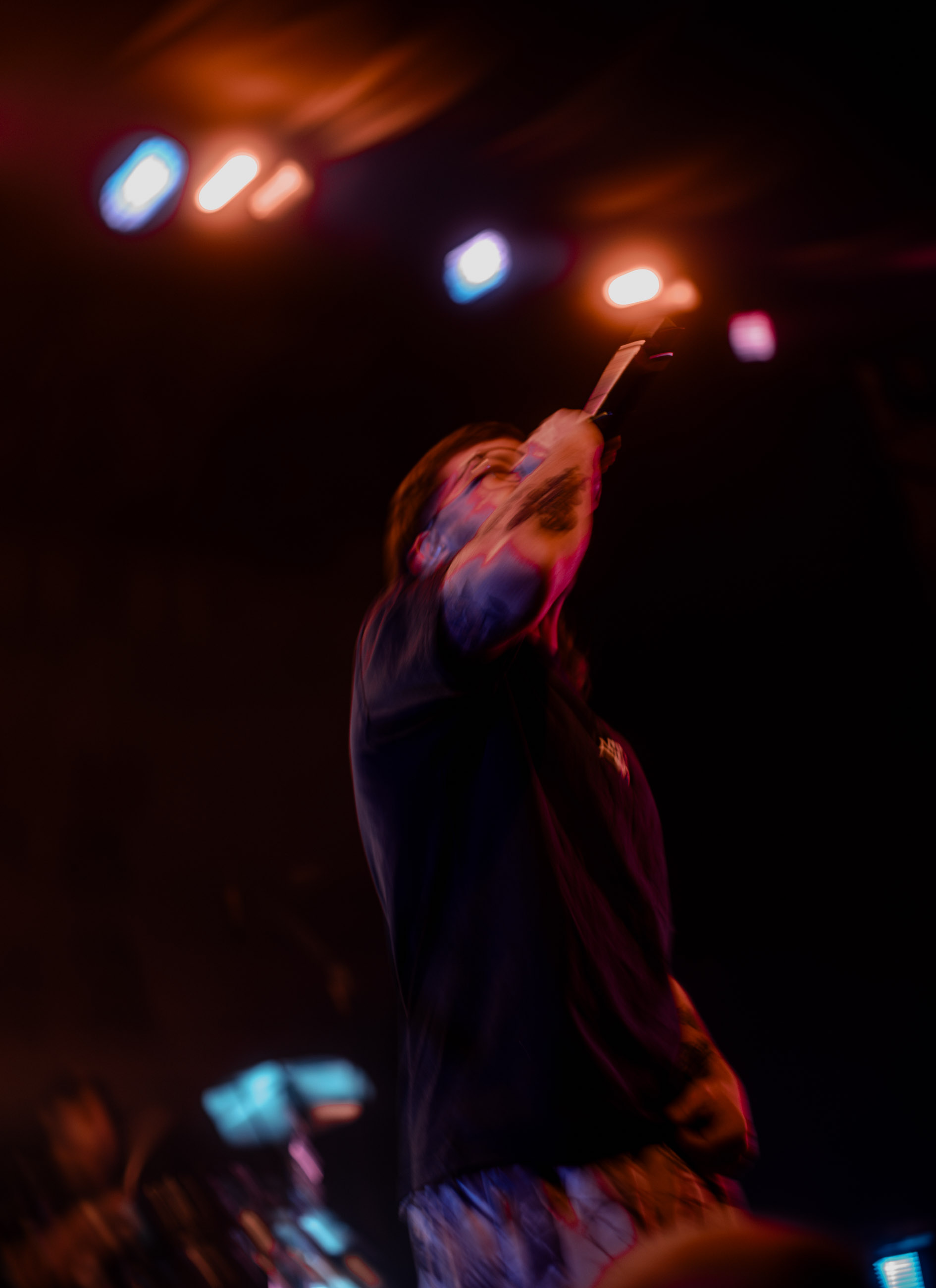 Belmont lead vocalist, Taz Johnson, passionately singing into the mic during their Denver concert at The Oriental Theater.