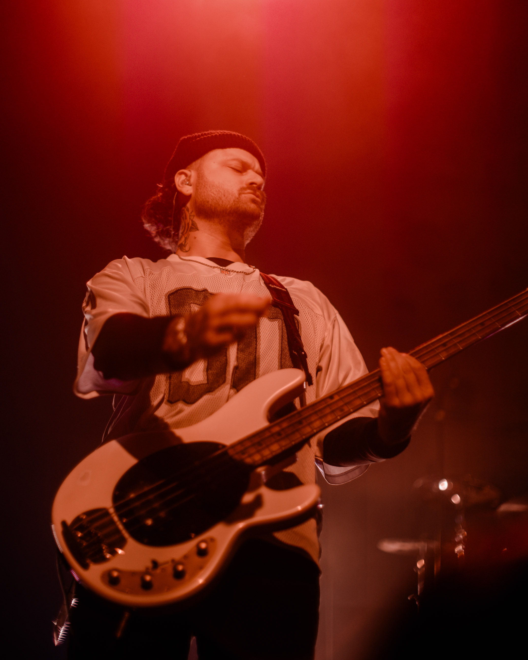 Belmont bassist playing under stage lights during a live performance in Denver, Colorado.