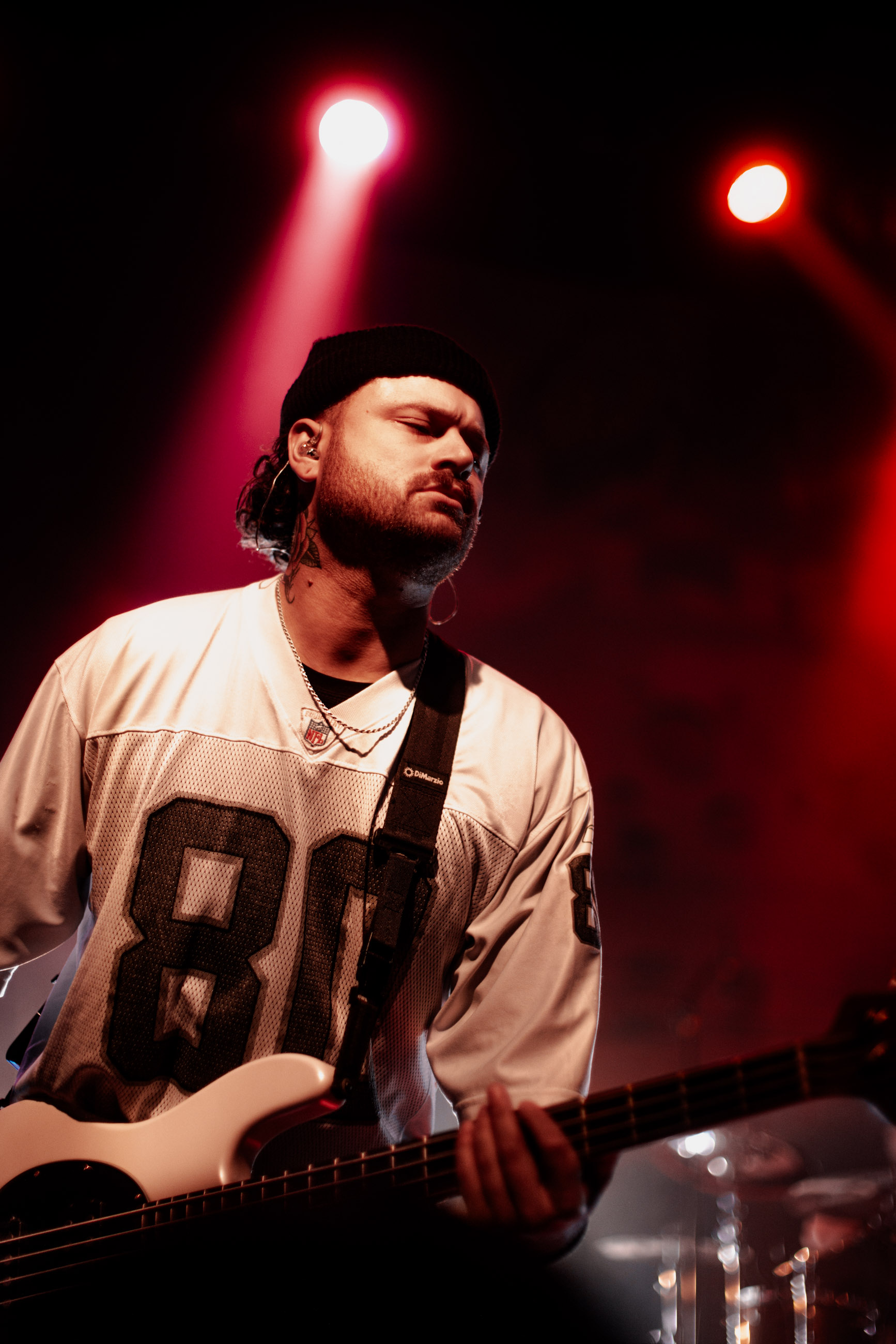 Belmont bassist playing under stage lights during a live performance in Denver, Colorado.